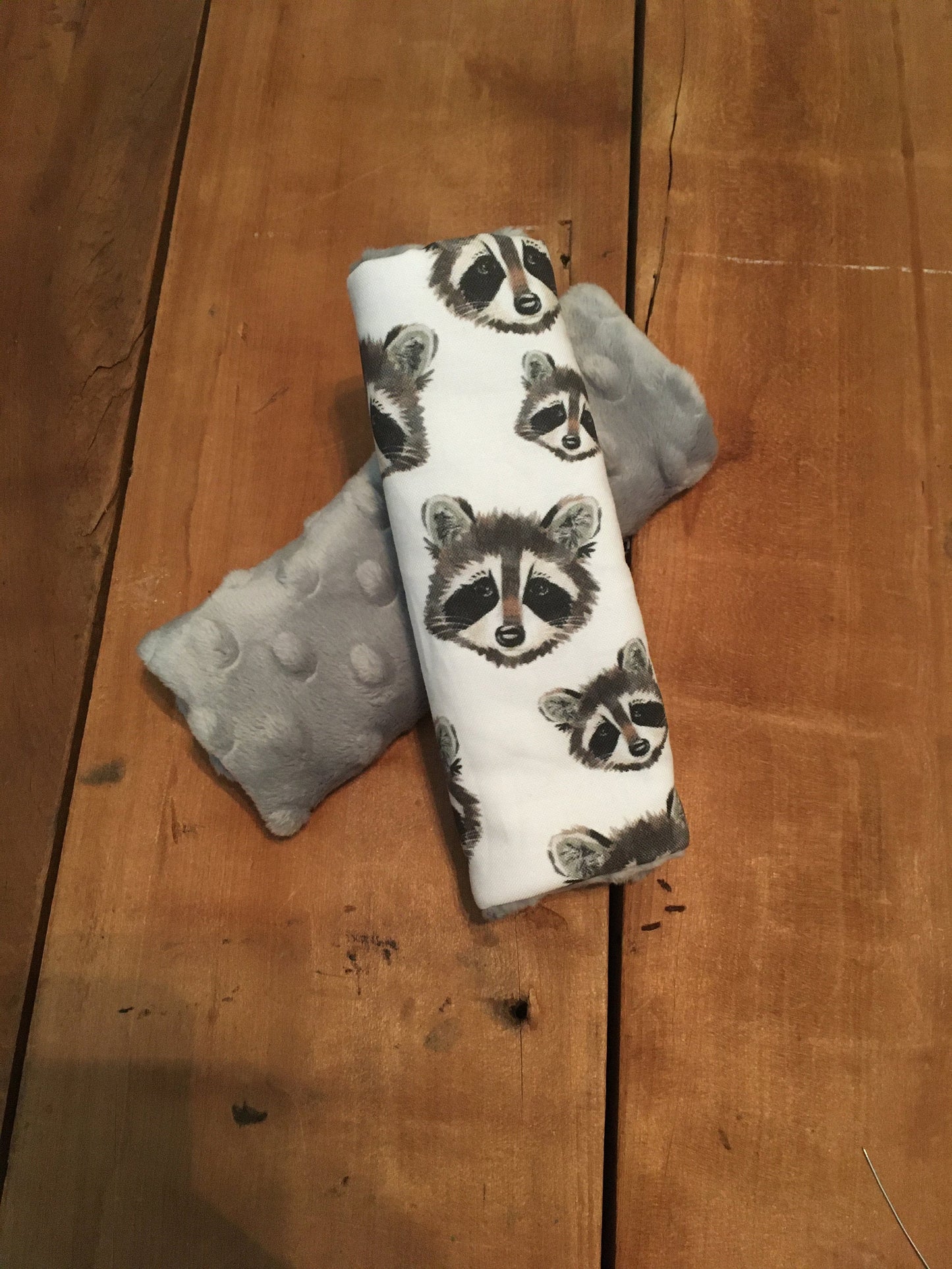 raccoon car seat strap covers shown in light gray