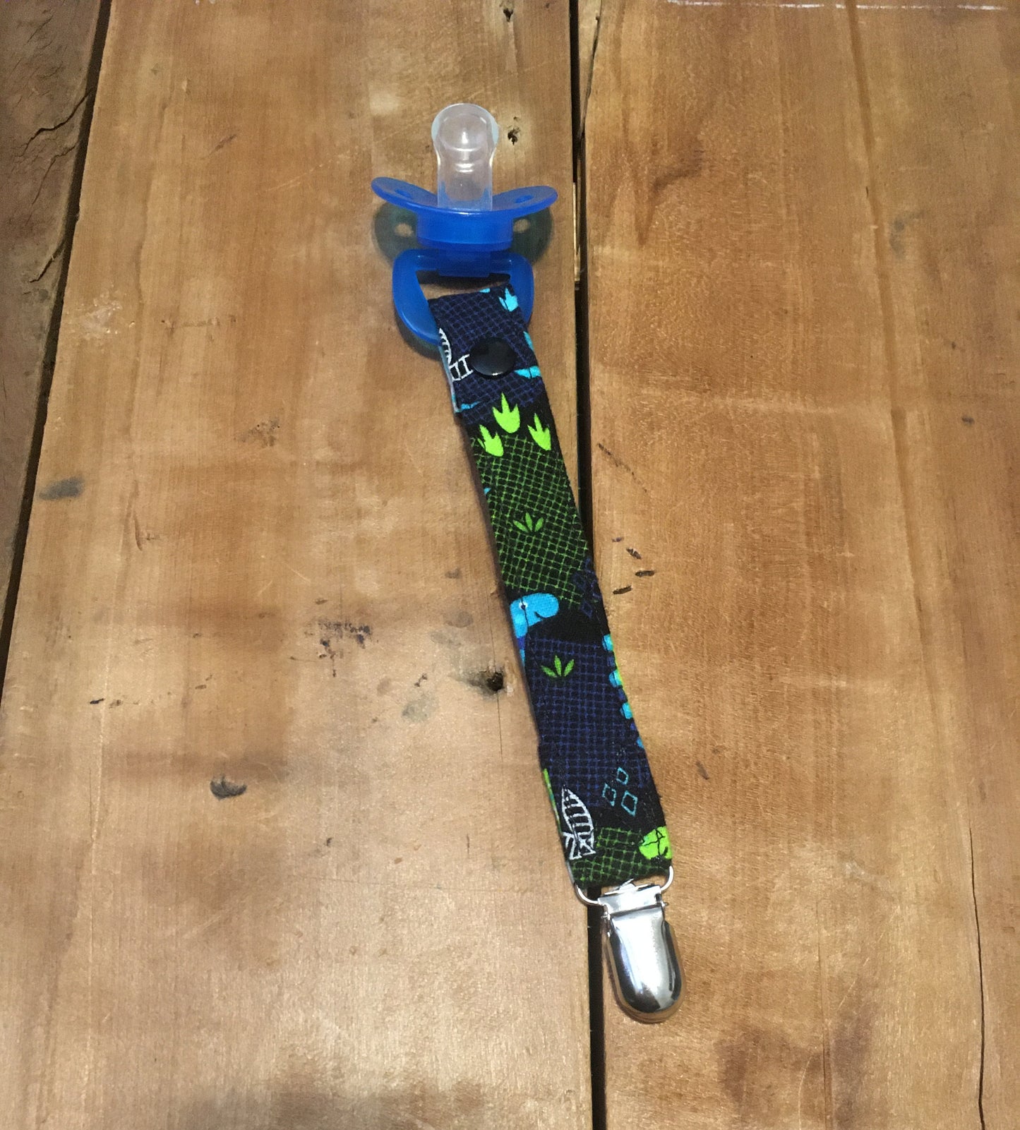 dinosaur pacifier clip shown with snap