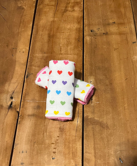 rainbow hearts car seat strap covers shown in the 5"size and pink minky back