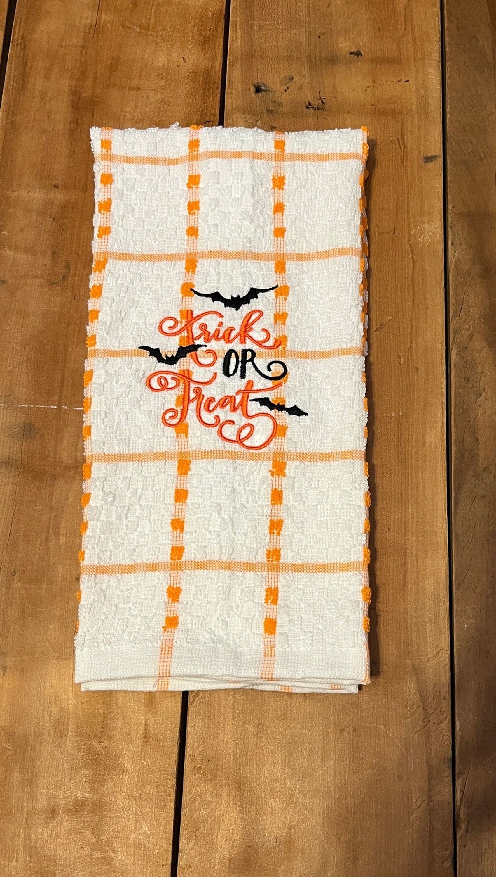 orange pumpkin face towel, orange and white stripe towel with trick or treat and bats embroidered towels