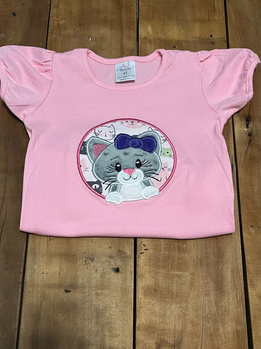 embroidered cat shirt, shown with pink shirt.